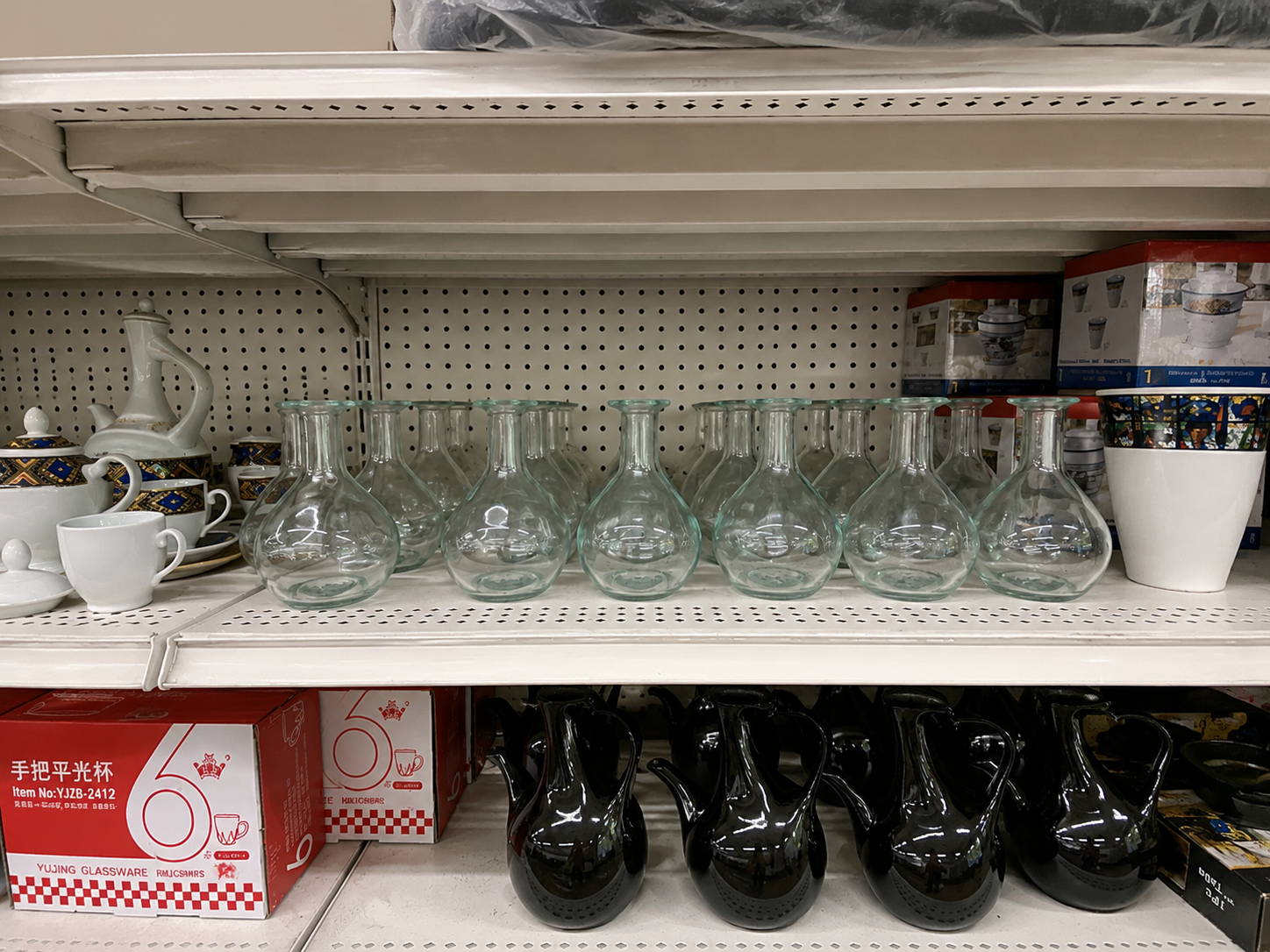 Glass bottles and white ceramic cups with red glassware packaging