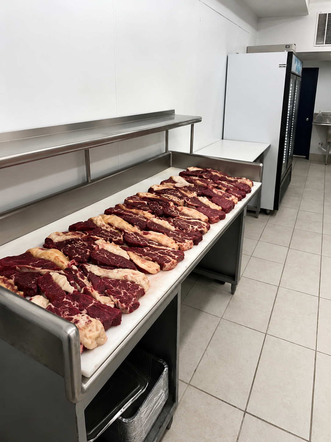 Butcher shop display with various beef steaks and cuts