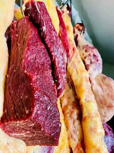 Fresh deep-red cut beef with marbled fat at the butcher counter